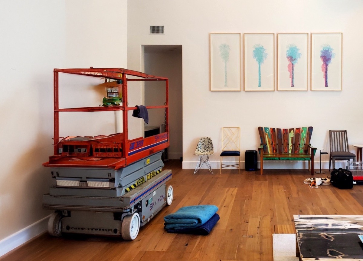 Art consultant guiding placement of a large work during installation