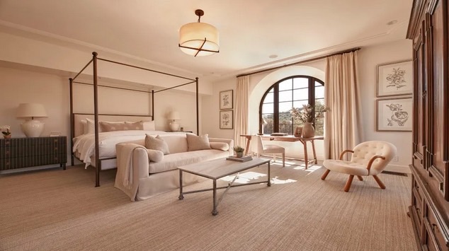 Guest suite with four-poster bed and framed botanical studies